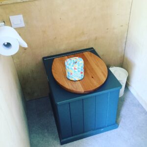 composting toilet with roll of toilet paper