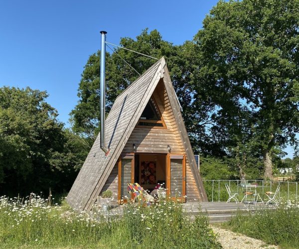 Tiny Homes Holidays - Eco-friendly lodges for off-grid vacations on the Isle of Wight, set in a natural meadow, adjacent to ancient woodland
